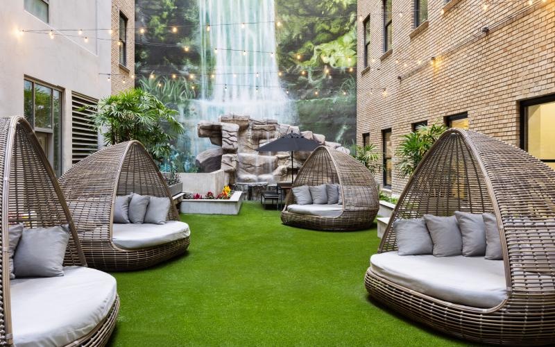 a courtyard with chairs and pods