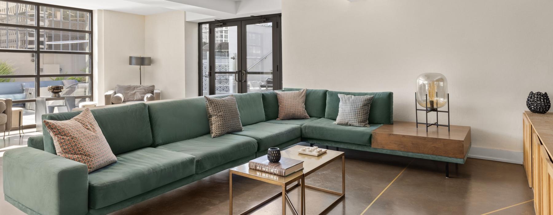 a living room with a green couch