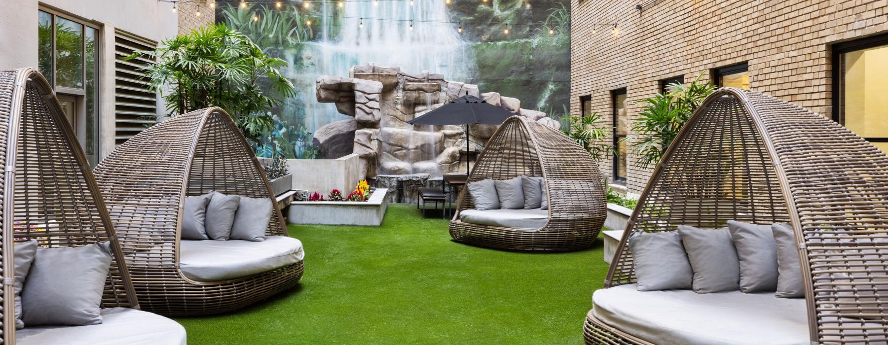 a courtyard with chairs and pods