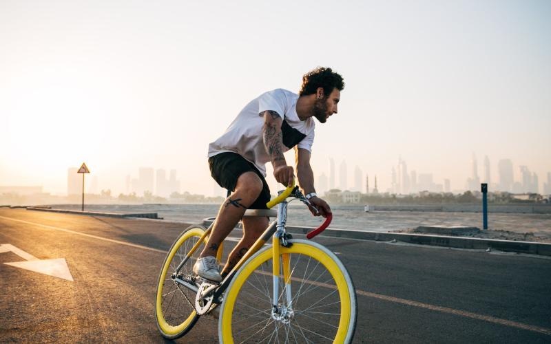 Find your perfect fit at Roosevelt Lofts a man riding a bicycle on a road